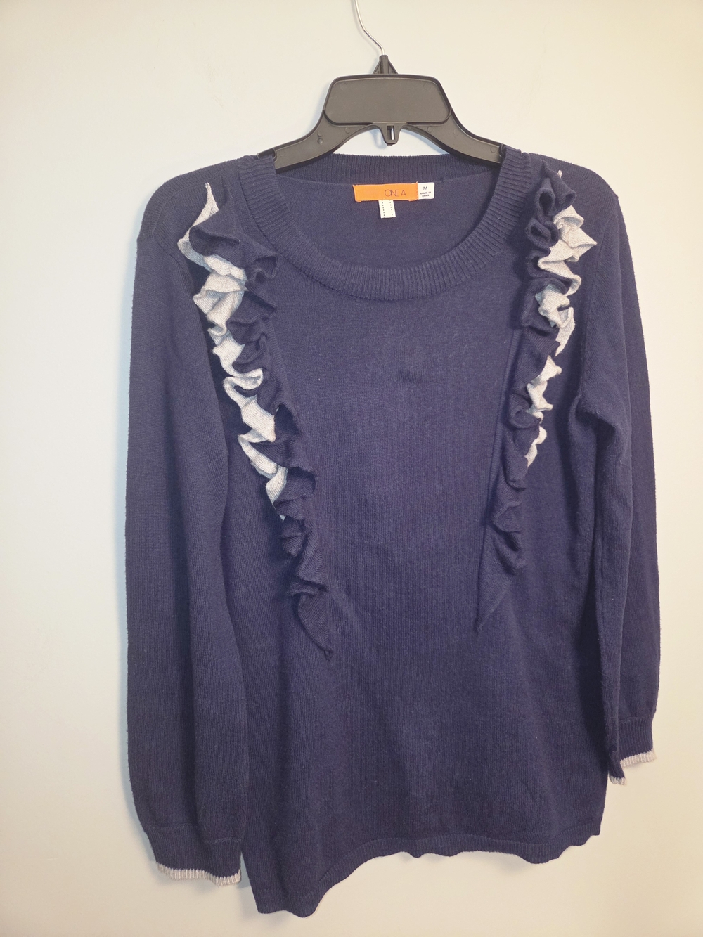 One A Navy Sweater with Light Gray Ruffle Accents